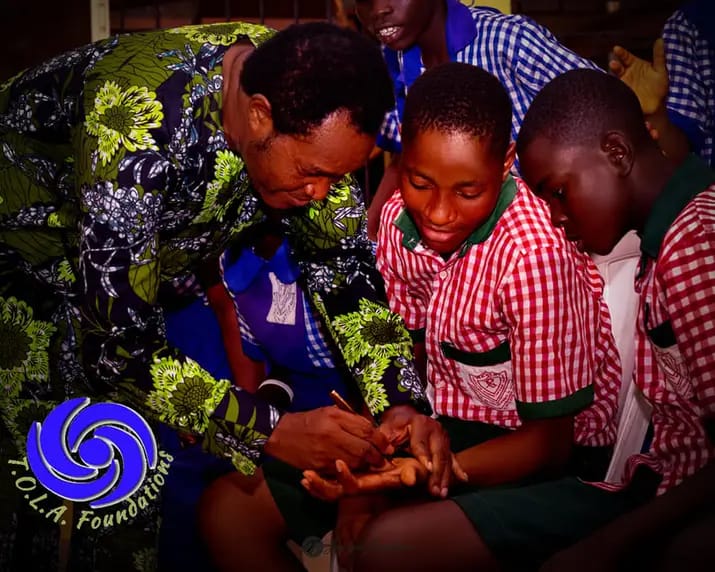 Pic: Dr. Odutola Ayorinde Odusanya shares happy moments with students at Wesley School for the Deaf and Hard of Hearing, in Nigeria. 
Photo by T.O.L.A